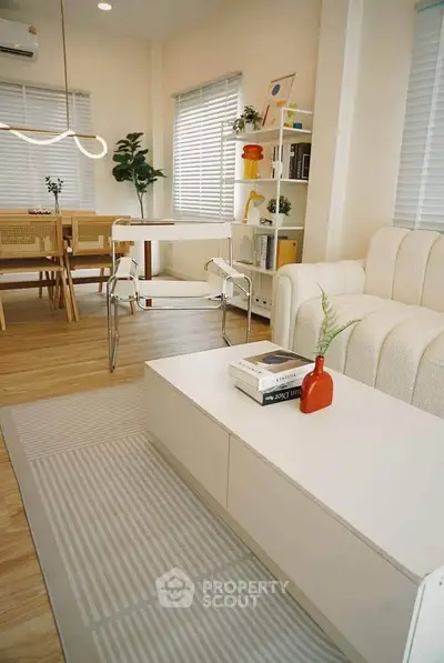 Stylish modern living room with cozy seating and elegant dining area, perfect for relaxation and entertaining.