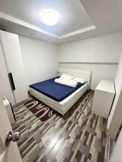 Modern bedroom with stylish flooring and minimalist decor
