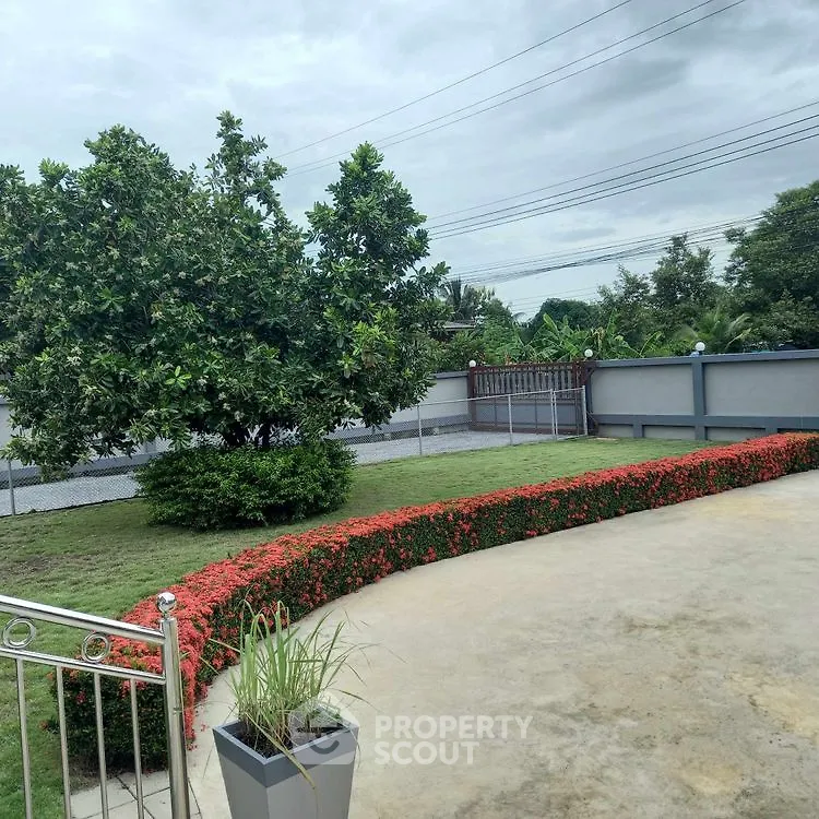Charming garden view with lush greenery and paved patio area.