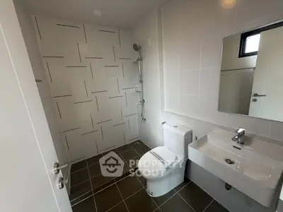 Modern bathroom with sleek fixtures and tiled shower area