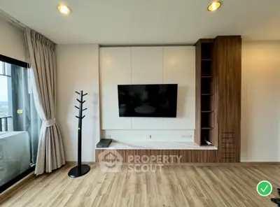 Modern living room with wall-mounted TV and wooden flooring