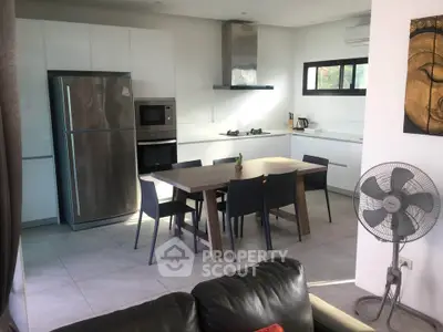Modern kitchen with sleek appliances and dining area in open layout design