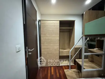 Modern interior with wooden closet and loft bed in a compact room