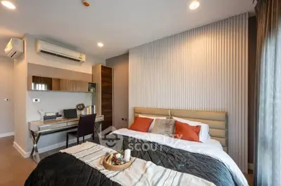 Modern bedroom with stylish decor and workspace, featuring cozy bedding and ambient lighting.
