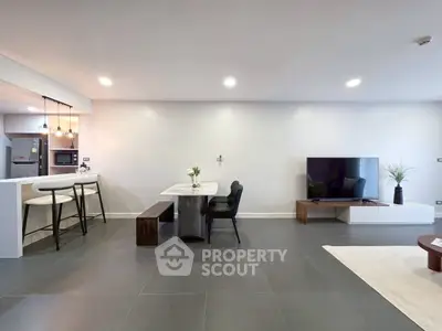 Spacious modern living room with open kitchen and sleek furnishings