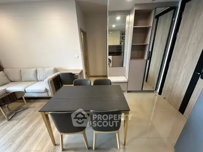 Modern living room with dining area and stylish furniture in a contemporary apartment.