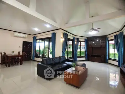 Spacious living room with modern furniture and large windows offering natural light.