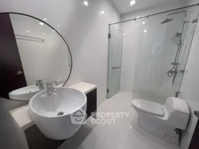 Modern bathroom with sleek fixtures and glass shower enclosure