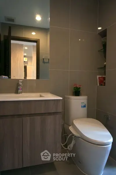 Modern bathroom with sleek fixtures and elegant cabinetry in a contemporary apartment.