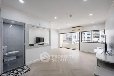 Spacious modern living room with balcony and city view