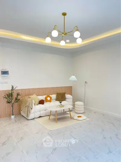 Modern living room with stylish lighting and cozy seating area on marble flooring.