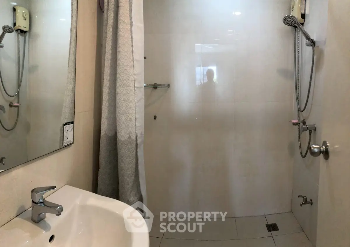 Modern bathroom with sleek fixtures and spacious shower area