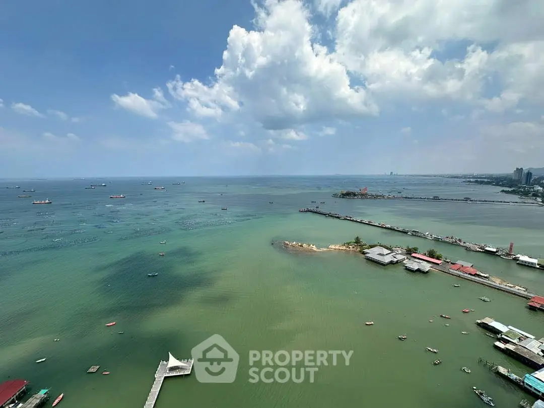 Stunning panoramic ocean view from high-rise building, perfect for luxury waterfront living.