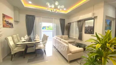 Elegant living room with modern decor and dining area, featuring stylish lighting and lush greenery.