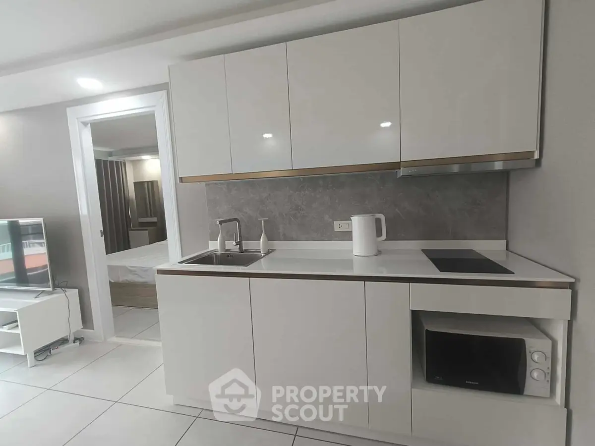 Modern kitchen with sleek cabinetry and integrated appliances in a stylish apartment.
