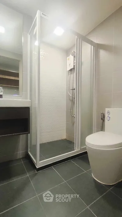 Modern bathroom with sleek shower enclosure and contemporary fixtures.