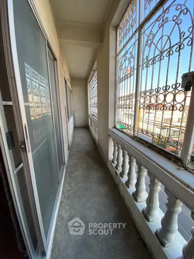 Charming balcony with ornate ironwork and city view, perfect for relaxation and enjoying the outdoors.