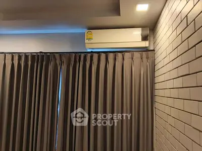 Modern interior with air conditioning and stylish curtains in a cozy living space.