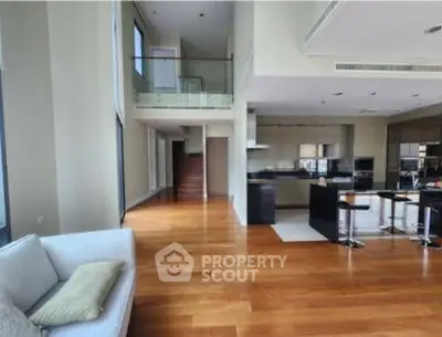 Spacious modern living room with open kitchen and elegant wooden flooring