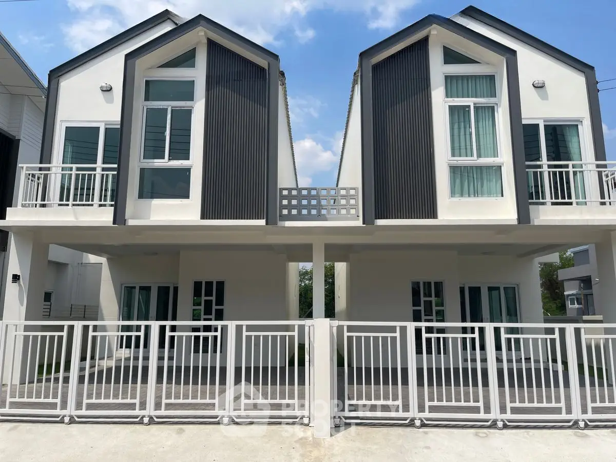 Modern duplex houses with sleek design and spacious balconies in a serene neighborhood.