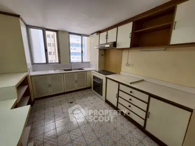 Spacious kitchen with ample storage and natural light in urban apartment