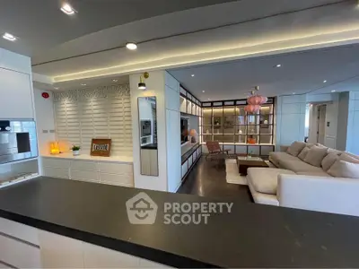 Luxurious open-plan living room with modern decor and elegant lighting