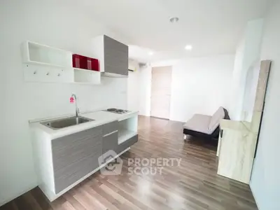 Modern minimalist kitchen with sleek design and open layout in a bright apartment.