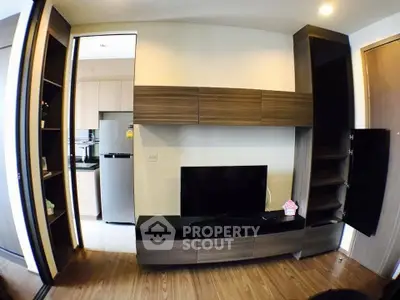 Modern living room with sleek wooden furniture and open kitchen view.