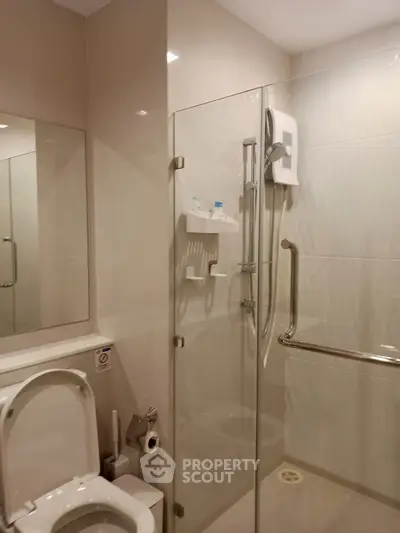 Modern bathroom with glass shower enclosure and sleek fixtures