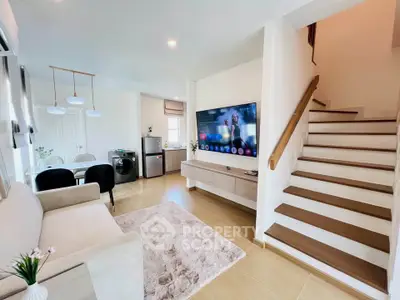 Modern living room with stylish decor, open layout, and staircase in a contemporary home.
