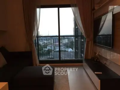 Chic living room with city view, modern decor, and floor-to-ceiling windows.