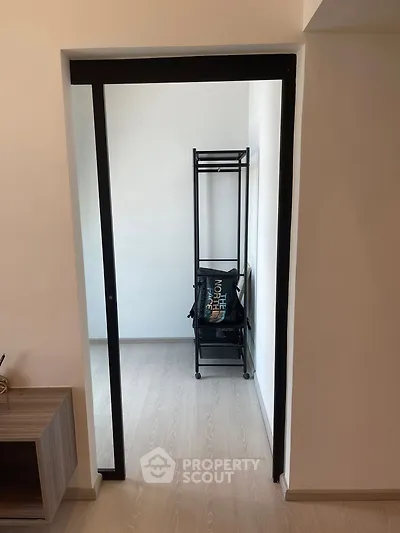 Minimalist storage area with sleek black shelving in modern apartment