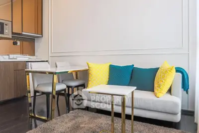 Modern living room with stylish furniture and vibrant cushions in a cozy apartment.