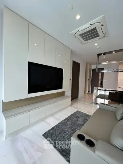 Modern living room with sleek built-in entertainment unit and air conditioning