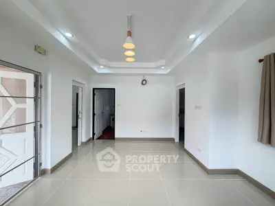 Spacious modern living room with elegant lighting and tiled flooring