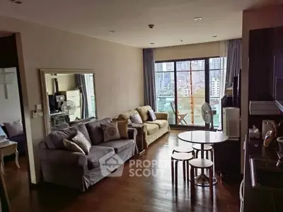 Spacious living room with city view, featuring cozy sofas and modern decor, perfect for urban living.