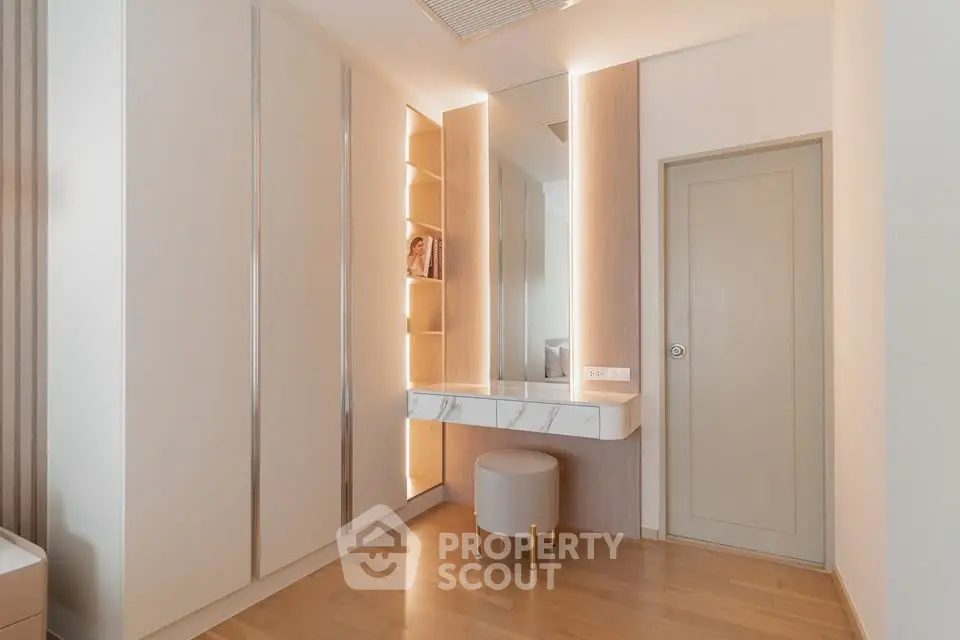 Elegant modern dressing area with built-in wardrobe and stylish lighting