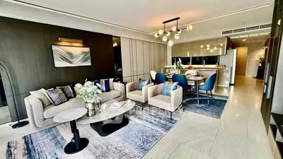 Luxurious modern living room with elegant decor and open dining area, perfect for stylish urban living.