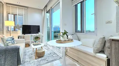 Chic modern living room with large windows and cozy seating area