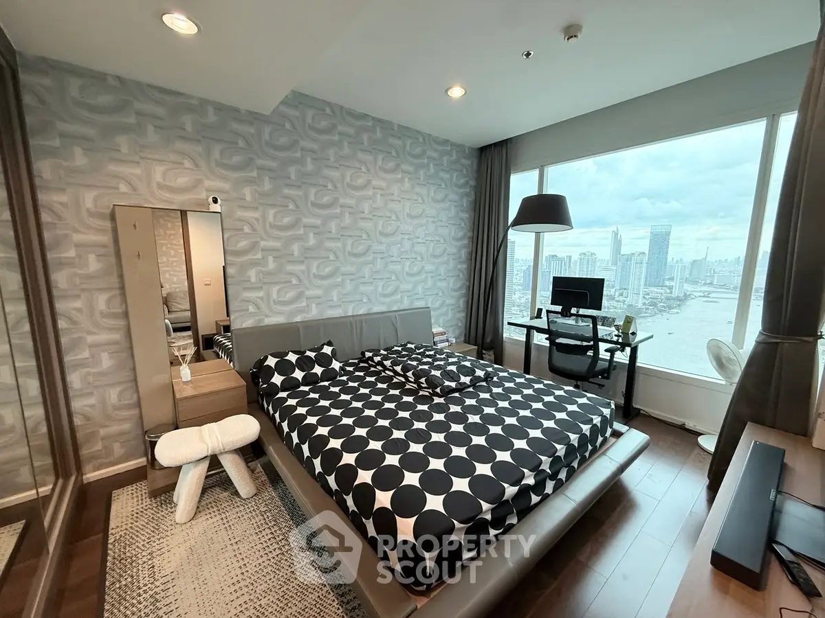 Modern bedroom with city view, stylish decor, and workspace in luxury apartment.