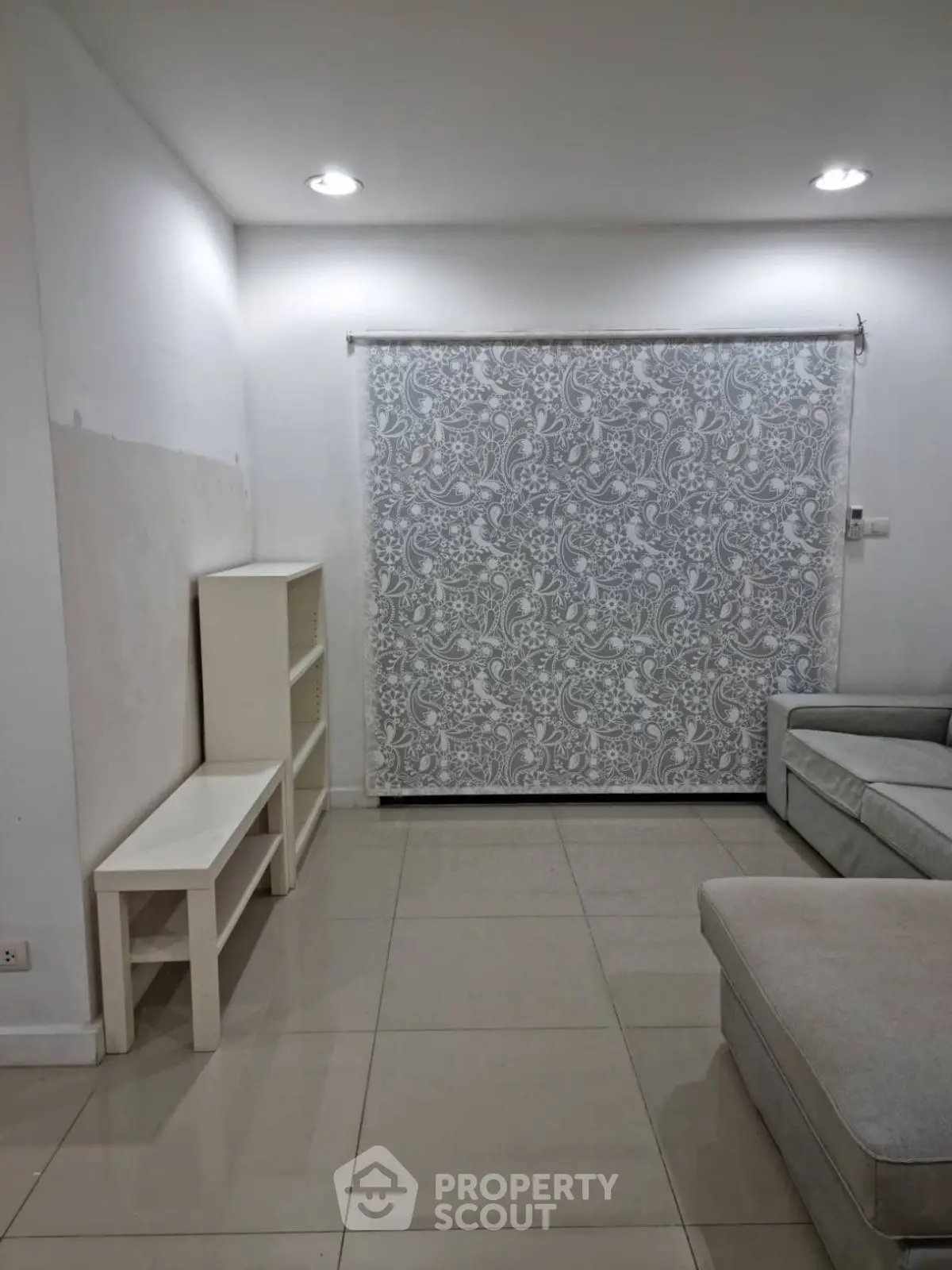 Spacious living room with elegant patterned curtain and modern furniture