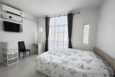 Bright and airy bedroom with modern furnishings and large window