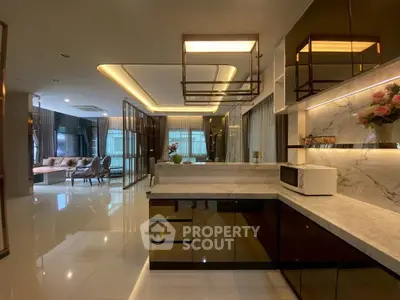 Luxurious open-plan kitchen and living room with modern design and elegant lighting.