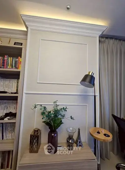 Elegant living room corner with modern decor and bookshelf