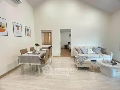 Spacious modern living room with elegant dining area and cozy sofa, perfect for stylish urban living.
