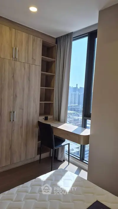 Modern bedroom with built-in wardrobe and city view, perfect for urban living.