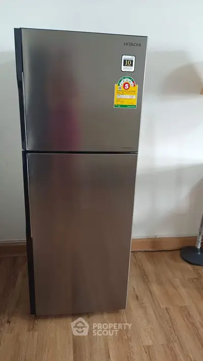 Modern stainless steel refrigerator in a stylish kitchen setting.
