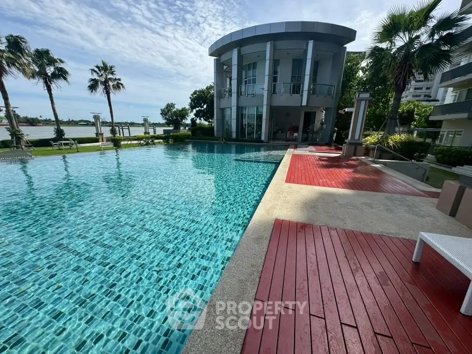 Luxurious poolside view with modern architecture and lush greenery, perfect for relaxation and leisure.