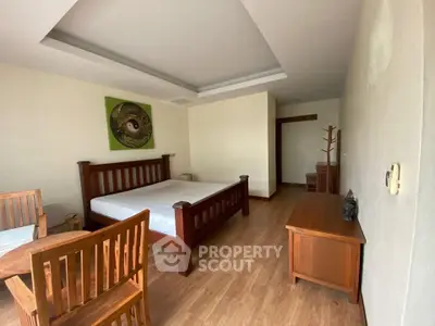 Spacious bedroom with wooden furniture and modern decor