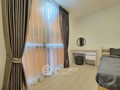 Modern bedroom with elegant curtains and stylish furniture, perfect for a cozy and serene living space.